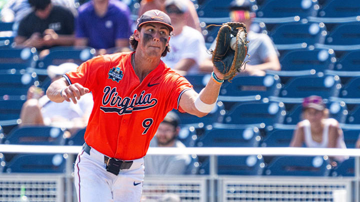 Jun 16, 2024; Omaha, NE, USA; Virginia Cavaliers first baseman Henry Ford (9) gets an out against the Florida State Seminoles during the seventh inning at Charles Schwab Field Omaha. Mandatory Credit: Dylan Widger-Imagn Images