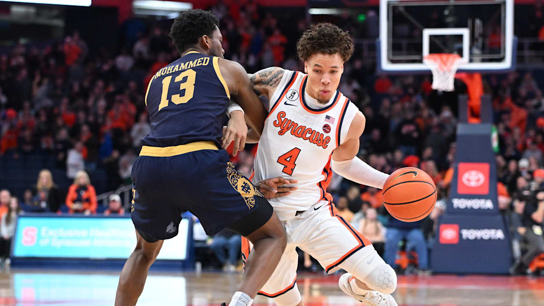 Jan 31, 2026; Syracuse, New York, USA; Syracuse Orange guard Nate Kingz (4) tries to move the ball past Notre Dame Fighting Irish guard Sir Mohammed (13) in the second half at the JMA Wireless Dome. Mandatory Credit: Mark Konezny-Imagn Images