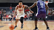 The Ville's David Johnson (13) makes his way around Sideline Cancer's Marcellus Earlington (11) during their game on Monday, July 22, 2024 in Louisville, Ky. at Freedom Hall during the second round of The Basketball Tournament.