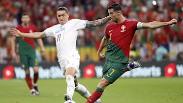 Portugal forward Cristiano Ronaldo shoots on goal against Uruguay forward Darwin Nunez during the 2022 FIFA World Cup