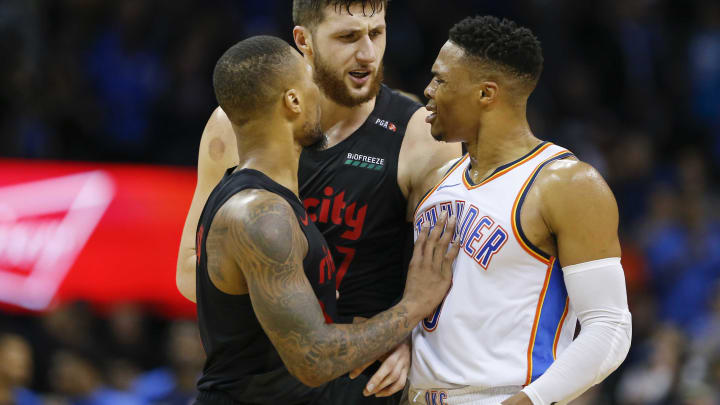 Portland Trail Blazers center Jusuf Nurkic, back, comes into a conversation Portland Trail Blazers guard Damian Lillard, left, and Oklahoma City Thunder guard Russell Westbrook, right, following the end of the game at Chesapeake Energy Arena. Oklahoma City won 123-114. Mandatory Credit: