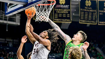 Feb 8, 2025; South Bend, Indiana, USA; Virginia Tech Hokies forward Mylyjael Poteat (34) goes up for a shot as Notre Dame Fighting Irish forward Nikita Konstantynovskyi (25) defends in the second half at the Purcell Pavilion. Mandatory Credit: Matt Cashore-Imagn Images