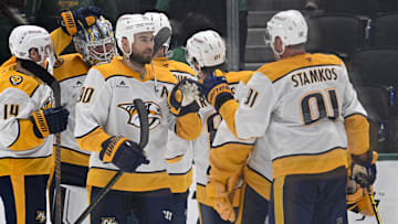 Dec 12, 2024; Dallas, Texas, USA;  Nashville Predators center Ryan O'Reilly (90) and center Steven Stamkos (91) celebrate on the ice after the Predators defeat the Dallas Stars at the American Airlines Center. Mandatory Credit: Jerome Miron-Imagn Images