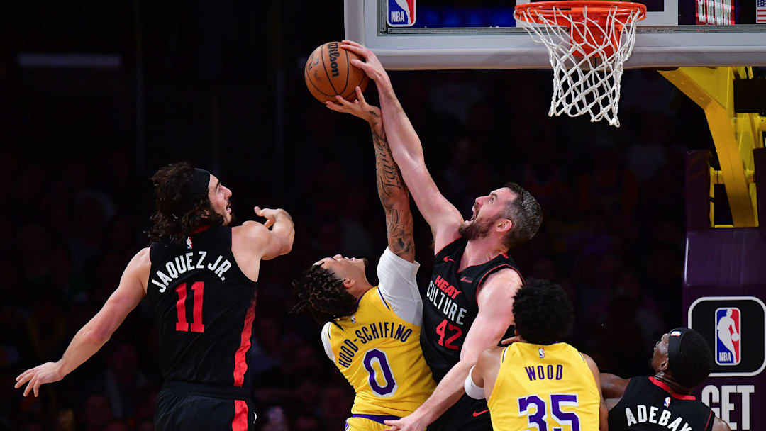 Jan 3, 2024; Los Angeles, California, USA; Miami Heat forward Kevin Love (42) blocks the shot of Los Angeles Lakers guard Jalen Hood-Schifino (0) as guard Jaime Jaquez Jr. (11) helps defend during the first half at Crypto.com Arena. Mandatory Credit: Gary A. Vasquez-Imagn Images