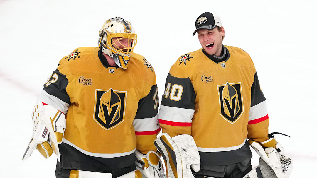 Apr 20, 2025; Las Vegas, Nevada, USA; Vegas Golden Knights goaltender Adin Hill (33) celebrates with goaltender Akira Schmid (40) after they defeated the Minnesota Wild 4-2 in game one of the first round of the 2025 Stanley Cup Playoffs at T-Mobile Arena. Mandatory Credit: Stephen R. Sylvanie-Imagn Images