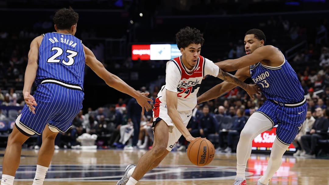 Nov 1, 2025; Washington, District of Columbia, USA; Washington Wizards guard Will Riley (27) drives to the basket as Orlando Magic forward Tristan da Silva (23) and Magic guard Jett Howard (13) defend in the second half at Capital One Arena. Mandatory Credit: Geoff Burke-Imagn Images