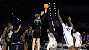 Mar 15, 2025; Fort Worth, TX, USA; Tulane Green Wave guard Rowan Brumbaugh (7) scores a three-point basket against Memphis Tigers forward Dain Dainja (42) during the first half at Dickies Arena. Mandatory Credit: Chris Jones-Imagn Images