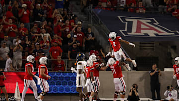 Sep 7, 2024; Tucson, Arizona, USA; Arizona Wildcats wide receiver Jeremiah Patterson (2) celebrates a touchdown with Arizona Wildcats offensive lineman Jonah Savaiinaea (71) during the third quarter against Northern Arizona Lumberjacks at Arizona Stadium. Mandatory Credit: Aryanna Frank-Imagn Images