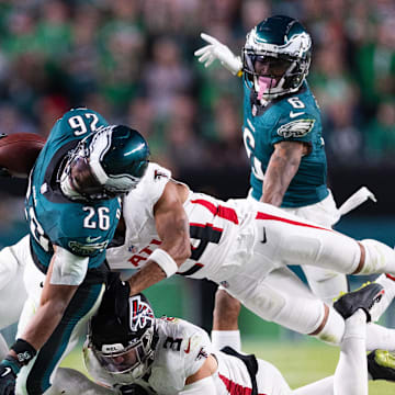 Sep 16, 2024; Philadelphia, Pennsylvania, USA; Philadelphia Eagles running back Saquon Barkley (26) is tackled by Atlanta Falcons safety Jessie Bates III (3) and cornerback A.J. Terrell (24) during the fourth quarter at Lincoln Financial Field. Mandatory Credit: Bill Streicher-Imagn Images