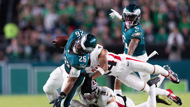 Sep 16, 2024; Philadelphia, Pennsylvania, USA; Philadelphia Eagles running back Saquon Barkley (26) is tackled by Atlanta Falcons safety Jessie Bates III (3) and cornerback A.J. Terrell (24) during the fourth quarter at Lincoln Financial Field. Mandatory Credit: Bill Streicher-Imagn Images