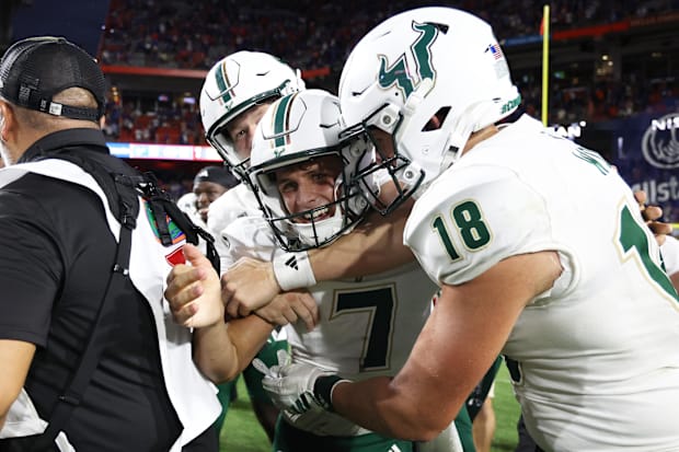 South Florida placekicker Nico Gramatica is congratulated after he made the game-winning field goal against Florida.