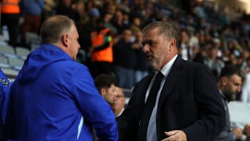 Mark Robins and Ange Postecoglu shaking hands at the Ricoh Arena last night