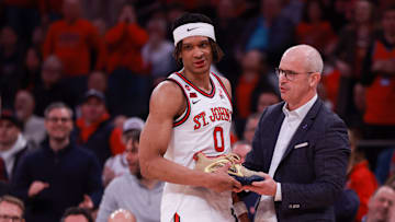 Connecticut v St. John's; UConn head coach Dan Hurley hands St. John's basketball forward Aaron Scott his sneaker after a play inside Madison Square Garden
