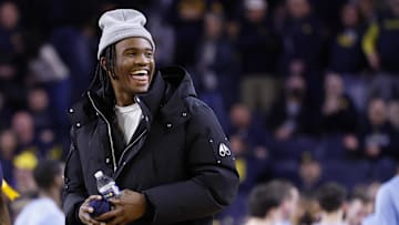 Jan 27, 2025; Ann Arbor, Michigan, USA;  Michigan Wolverines quarterback Bryce Underwood participates in a t-shirt toss during a time out in the second half against the Penn State Nittany Lions at Crisler Center. Mandatory Credit: Rick Osentoski-Imagn Images