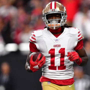 January 1, 2023; Paradise, Nevada, USA; San Francisco 49ers wide receiver Brandon Aiyuk (11) scores a touchdown against the Las Vegas Raiders during the first half at Allegiant Stadium. Mandatory Credit: Gary A. Vasquez-USA TODAY Sports