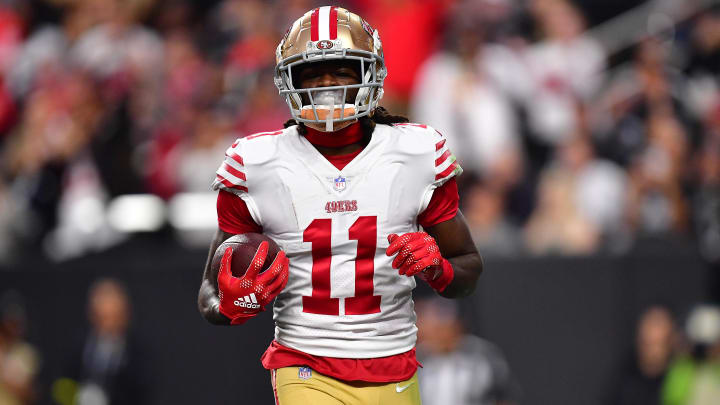 January 1, 2023; Paradise, Nevada, USA; San Francisco 49ers wide receiver Brandon Aiyuk (11) scores a touchdown against the Las Vegas Raiders during the first half at Allegiant Stadium. Mandatory Credit: Gary A. Vasquez-USA TODAY Sports