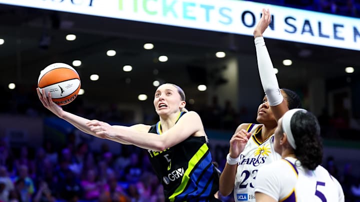 Dallas Wings guard Paige Bueckers shoots past Los Angeles Sparks forward Azura Stevens. Dallas Wings guard Paige Bueckers shoots past Los Angeles Sparks forward Azura Stevens.
