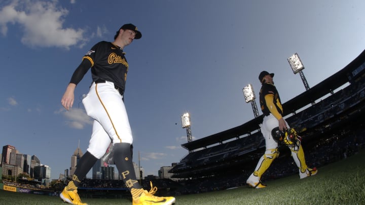 Pittsburgh Pirates starting pitcher Paul Skenes (left) walks in from the bullpen to pitch against the Cincinnati Reds at PNC Park on Aug 22.