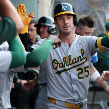 Jul 25, 2024; Anaheim, California, USA;  Oakland Athletics designated hitter Brent Rooker (25) is greeted by teammates in the dugout after hitting a home run during the first inning against the Los Angeles Angels at Angel Stadium. Mandatory Credit: Kiyoshi Mio-USA TODAY Sports