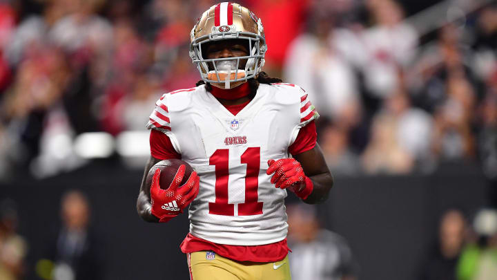 January 1, 2023; Paradise, Nevada, USA; San Francisco 49ers wide receiver Brandon Aiyuk (11) scores a touchdown against the Las Vegas Raiders during the first half at Allegiant Stadium.