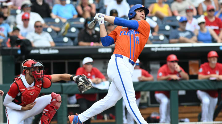 Jun 17, 2024; Omaha, NE, USA;  Florida Gators starting pitcherdesignated hitter Jac Caglianone (14) hits a three run home run against the NC State Wolfpack during the second inning at Charles Schwab Field Omaha. Mandatory Credit: Steven Branscombe-USA TODAY Sports