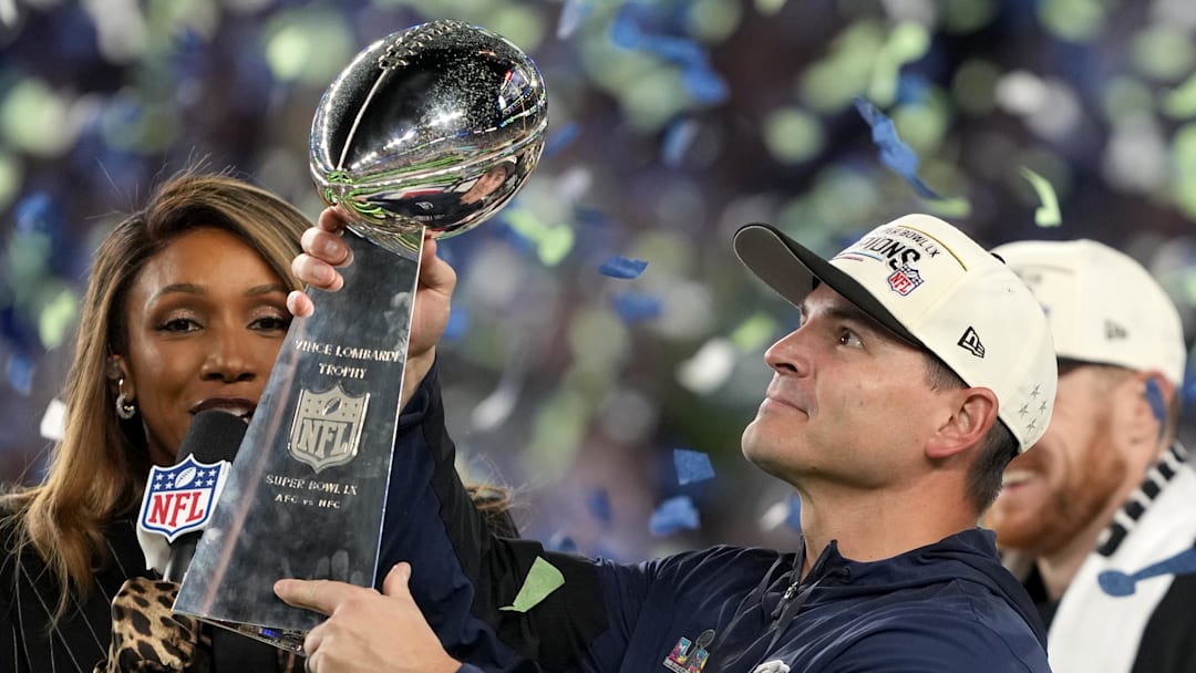 Feb 8, 2026; Santa Clara, CA, USA; Seattle Seahawks head coach Mike MacDonald celebrates with the Vince Lombardi trophy on the podium after defeating the New England Patriots in Super Bowl LX at Levi's Stadium. Mandatory Credit: Kyle Terada-Imagn Images