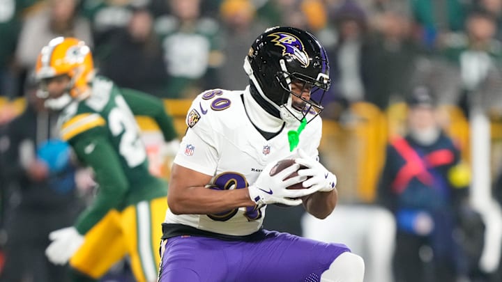 Dec 27, 2025; Green Bay, Wisconsin, USA; Baltimore Ravens tight end Isaiah Likely (80) catches a pass against the Green Bay Packers during the first quarter at Lambeau Field. Mandatory Credit: Kayla Wolf-Imagn Images