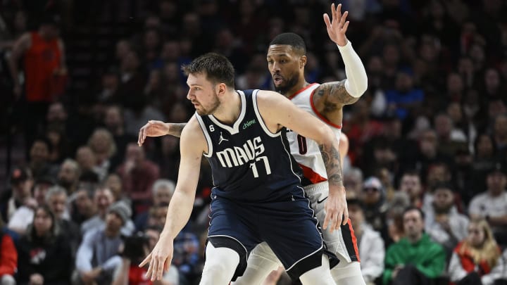 Jan 14, 2023; Portland, Oregon, USA; Dallas Mavericks guard Luka Doncic (77) dribbles the ball during the first half against Portland Trail Blazers guard Damian Lillard (0) at Moda Center. Mandatory Credit: Troy Wayrynen-USA TODAY Sports