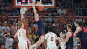 Dec 3, 2025; Austin, Texas, USA; Virginia Cavaliers center Johann Grunloh (17) dunks against Texas Longhorns center Matas Vokietaitis (8) during the first half at Moody Center. Mandatory Credit: Dustin Safranek-Imagn Images
