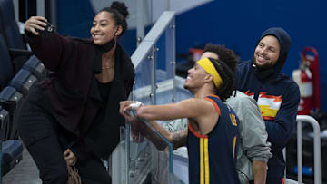 Sydel Curry (far left) takes a selfie with Golden State Warriors guard Damion Lee (second from left), Philadelphia 76ers guard Seth Curry (second from right), and Warriors guard Stephen Curry (far right) after the game at Chase Center. 