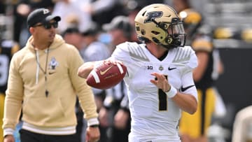 Purdue Boilermakers quarterback Hudson Card warms up as coach Ryan Walters observes