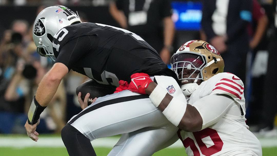 Aug 27, 2026; Paradise, Nevada, USA;  San Francisco 49ers defensive end Keion White (56) tackles Las Vegas Raiders quarterback Fernando Mendoza (15) during the second quarter at Allegiant Stadium.  Mandatory Credit: Kirby Lee-Imagn Images