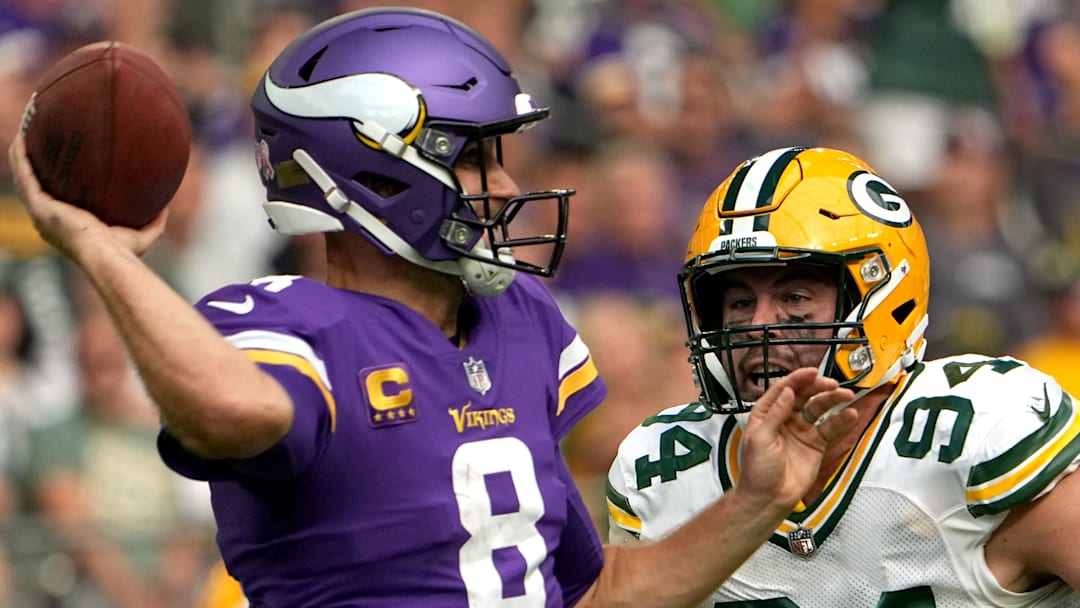 Green Bay Packers defensive end Dean Lowry (94) pressures Minnesota Vikings quarterback Kirk Cousins in 2022.