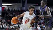 Nov 3, 2025; Cincinnati, Ohio, USA;  Cincinnati Bearcats forward Baba Miller (18) drives to the basket against Western Carolina Catamounts forward Samuel Dada (12) in the first half at Fifth Third Arena. Mandatory Credit: Aaron Doster-Imagn Images