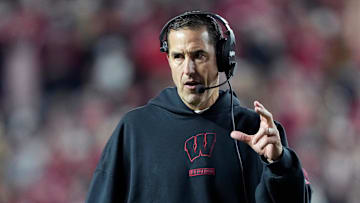 Nov 22, 2025; Madison, Wisconsin, USA; Wisconsin Badgers head coach Luke Fickell talks to his team during the second half against the Illinois Fighting Illini at Camp Randall Stadium. Mandatory Credit: Kayla Wolf-Imagn Images