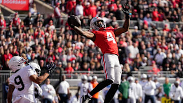 Ohio State Buckeyes wide receiver Jeremiah Smith (4) catches a touchdown pass in front of Penn State Nittany Lions cornerback Elliot Washington II (9) during the NCAA football game at Ohio Stadium in Columbus on Nov. 1, 2025.