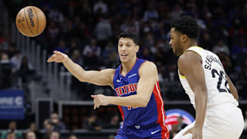 Dec 19, 2024; Detroit, Michigan, USA;  Detroit Pistons forward Simone Fontecchio (19) passes defended by Utah Jazz forward Brice Sensabaugh (28) in the first half at Little Caesars Arena. Mandatory Credit: Rick Osentoski-Imagn Images