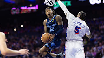 Nov 2, 2024; Philadelphia, Pennsylvania, USA; Memphis Grizzlies guard Ja Morant (12) drives for a score past Philadelphia 76ers center Andre Drummond (5) during the third quarter at Wells Fargo Center. Mandatory Credit: Bill Streicher-Imagn Images