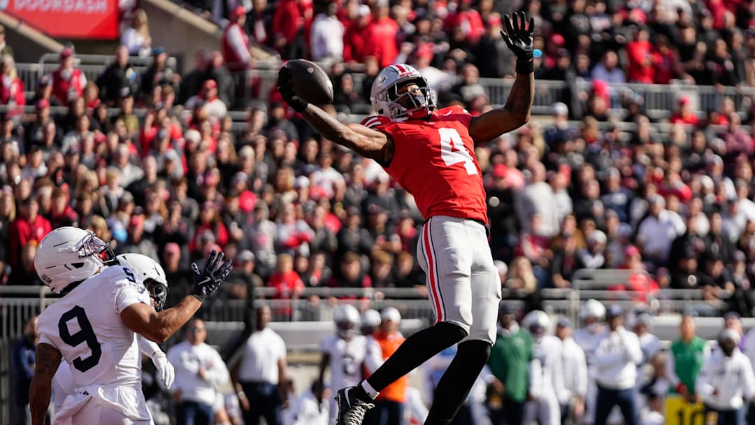Ohio State Buckeyes wide receiver Jeremiah Smith (4) catches a touchdown pass in front of Penn State Nittany Lions cornerback Elliot Washington II (9) during the NCAA football game at Ohio Stadium in Columbus on Nov. 1, 2025.