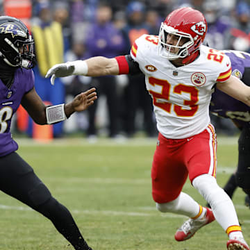 Jan 28, 2024; Baltimore, Maryland, USA; Kansas City Chiefs linebacker Drue Tranquill (23) chases Baltimore Ravens quarterback Lamar Jackson (8) in the AFC Championship football game at M&T Bank Stadium. Mandatory Credit: Geoff Burke-Imagn Images