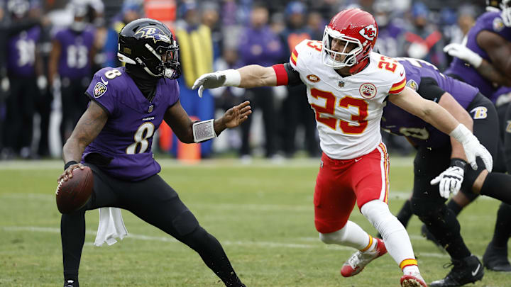 Jan 28, 2024; Baltimore, Maryland, USA; Kansas City Chiefs linebacker Drue Tranquill (23) chases Baltimore Ravens quarterback Lamar Jackson (8) in the AFC Championship football game at M&T Bank Stadium. Mandatory Credit: Geoff Burke-Imagn Images