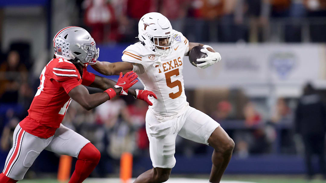 Texas Longhorns wide receiver Ryan Wingo runs against Ohio State Buckeyes cornerback Denzel Burke during the first quarter of the College Football Playoff semifinal in the Cotton Bowl at AT&T Stadium.