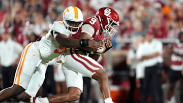 Oklahoma Sooners quarterback Michael Hawkins Jr. (9) is brought down by Tennessee Volunteers defensive lineman Jayson Jenkins (97) during a college football game between the University of Oklahoma Sooners (OU) and the Tennessee Volunteers at Gaylord Family - Oklahoma Memorial Stadium in Norman, Okla., Saturday, Sept. 21, 2024.