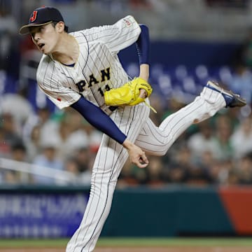 Mar 20, 2023; Miami, Florida, USA; Japan starting pitcher Roki Sasaki (14) delivers a pitch during the first inning against Mexico at LoanDepot Park. Mandatory Credit: Sam Navarro-Imagn Images