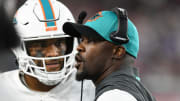 Sep 12, 2021; Foxborough, Massachusetts, USA; Miami Dolphins head coach Brian Flores talks with quarterback Tua Tagovailoa (1) during a timeout during the second half of a game against the New England Patriots at Gillette Stadium.