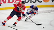 Jun 17, 2025; Sunrise, Florida, USA; Florida Panthers defenseman Niko Mikkola (77) and Edmonton Oilers center Connor McDavid (97) skate after the puck during the second period in game six of the 2025 Stanley Cup Final at Amerant Bank Arena. Mandatory Credit: Jim Rassol-Imagn Images