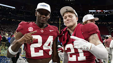 Alabama Crimson Tide wide receiver Emmanuel Henderson Jr. (24) and defensive back Jake Pope (21) celebrate after defeating the Georgia Bulldogs in the SEC championship game at Mercedes-Benz Stadium. 