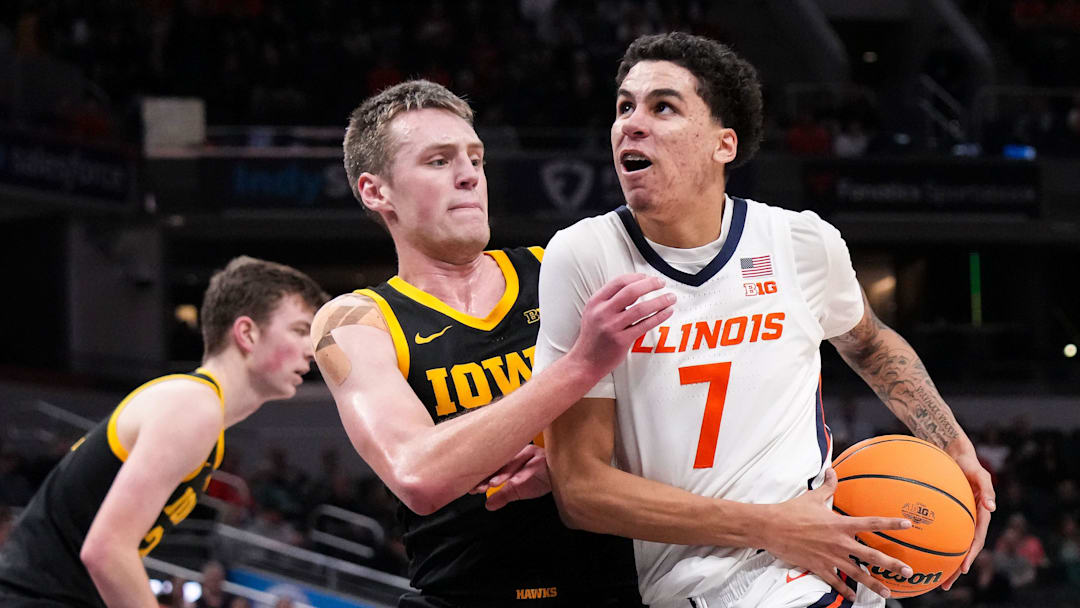 Illinois Fighting Illini forward Will Riley (7) rushes past Iowa Hawkeyes forward Payton Sandfort (20) on Thursday, March 13, 2025, during the second round of the men's Big Ten tournament at Gainbridge Fieldhouse in Indianapolis. The Illinois Fighting Illini defeated the Iowa Hawkeyes, 106-94.