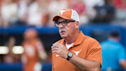 Jun 5, 2025; Oklahoma City, OK, USA;  
Texas Longhorns head coach Mike White heads to the third base coaches box in the second inning against the Texas Tech Red Raiders during game two of the NCAA Softball Women's College World Series finals at Devon Park. Mandatory Credit: Brett Rojo-Imagn Images