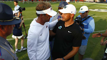 Sep 20, 2025; Oxford, Mississippi, USA; Mississippi Rebels head coach Lane Kiffin (left) and Tulane Green Wave head coach Jon Sumrall (right) embrace after the game at Vaught-Hemingway Stadium. Mandatory Credit: Petre Thomas-Imagn Images
